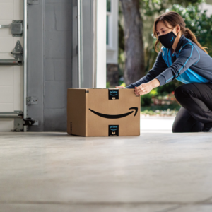 Amazon driver delivering packages into a myQ enabled garage using Amazon Key In-Garage Delivery for Prime Members